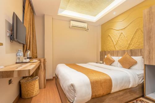 a hotel room with a bed and a television at Divya Boutique Inn in Kathmandu
