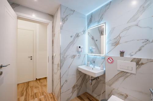 a bathroom with a sink and a mirror at Vila Amare in Sarandë