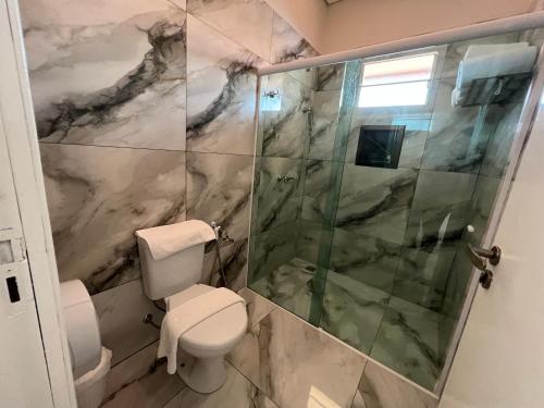 a bathroom with a toilet and a shower at Hotel Dolce Dulce in Olímpia