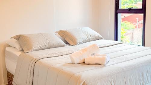 a large white bed with two pillows on it at Civis Jardinia Studio Close to Everything in Luque