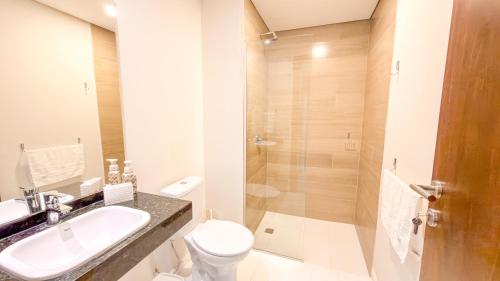 a bathroom with a toilet and a sink and a shower at Civis Jardinia Studio Close to Everything in Luque