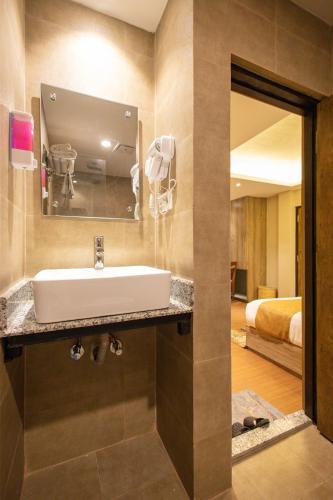 a bathroom with a sink and a mirror at Divya Boutique Inn in Kathmandu