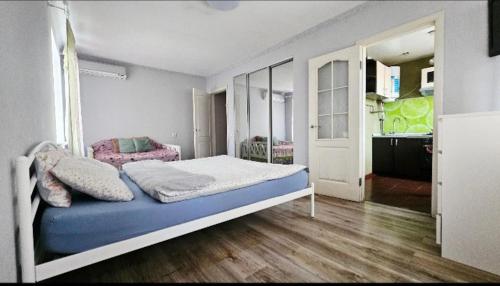 a bedroom with a bed with a blue and white mattress at 1 комнатная квартира, левый берег, Пр Калнышевского, пр Слобожанский, 6 городская клиника in Nizhnedneprovsk