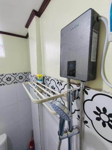 a monitor on a stand in a bathroom at G & B Transient House in San Jose