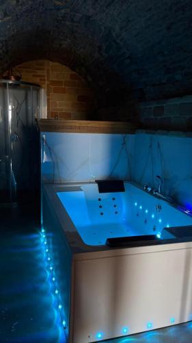 a bath tub with blue lighting in a tunnel at Rabat Home Luxury in Tursi