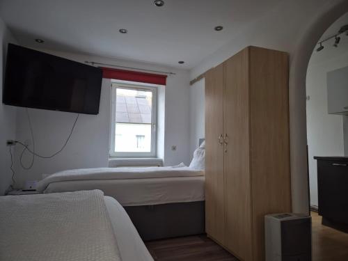 a bedroom with a bed and a dresser with a window at Apartment Krummnußbaum, Donau & Wachau in Krumnussbaum an der Donauuferbahn