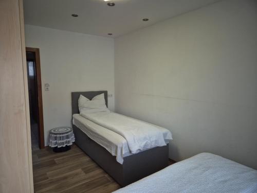 a small bedroom with two beds and a mirror at Apartment Krummnußbaum, Donau & Wachau in Krumnussbaum an der Donauuferbahn