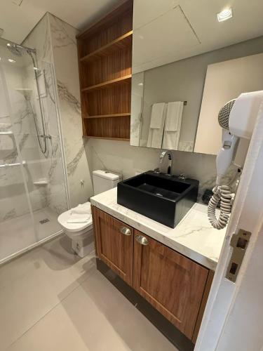 a bathroom with a sink and a toilet and a shower at Dream Flat Pinheiros in São Paulo