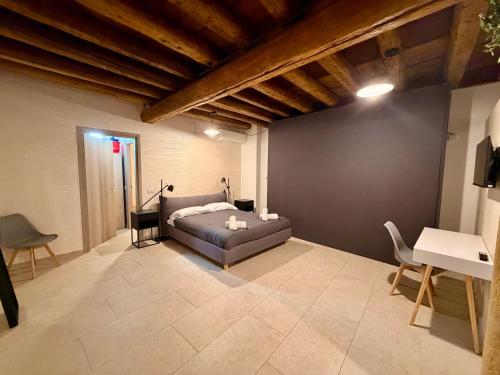 a bedroom with a bed and a table and chairs at Palazzo Giulietta in Verona