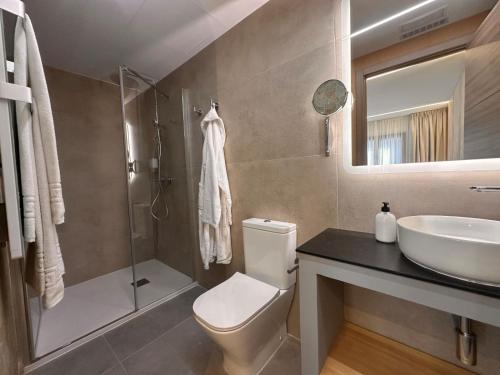 a bathroom with a toilet and a sink and a shower at ND Hoteles in Valdemoro
