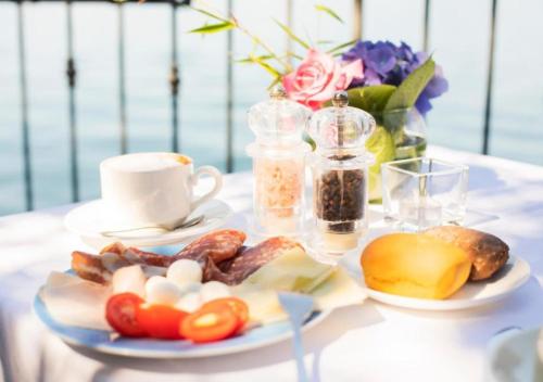 a table with a plate of food and a cup of coffee at Casa La Vigna by Villa Porta Collection in Luino