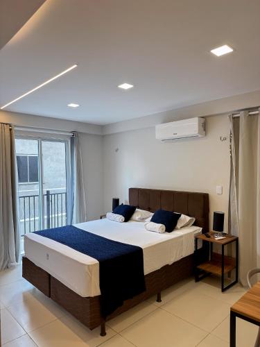 a bedroom with a large bed and a window at Home Studio in Sobral