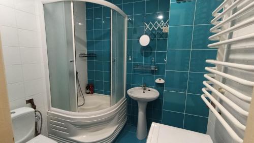 a bathroom with a shower and a sink and a toilet at Home for you in Ternopil
