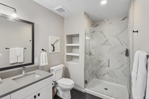 a white bathroom with a shower and a toilet at Sentral Old Town in Scottsdale
