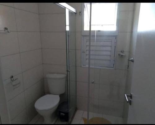 a bathroom with a toilet and a glass shower at Dunas de Guarajuba in Camacari