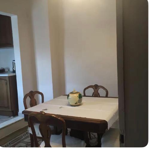 a dining room table with chairs and a vase on it at Via Roma 131 in Montevarchi