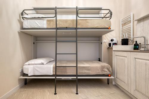 a bedroom with two bunk beds in a room at Your House Rooms in Genoa