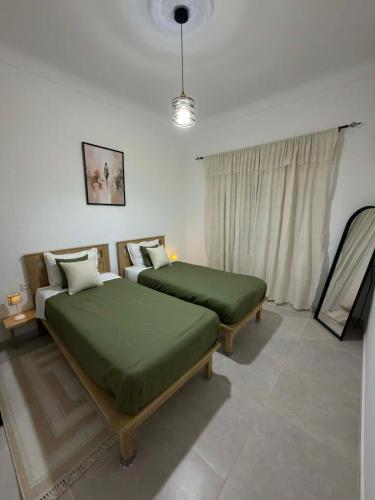 a bedroom with two beds and a window at Casa Shala in Tunis