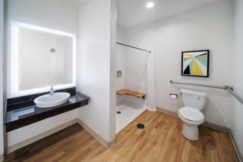 a bathroom with a white toilet and a sink at Candlewood Suites - Muskogee by IHG in Muskogee