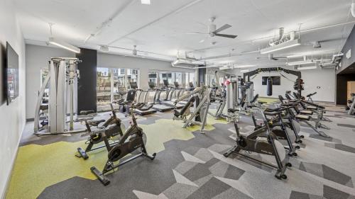 a gym with rows of exercise bikes and treadmills at Sentral SoBro in Nashville