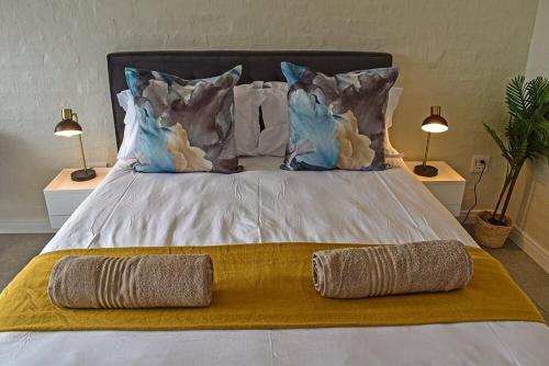 a bed with two lamps and two pillows on it at 1009 Studio Apartment Pont de Val in Parys