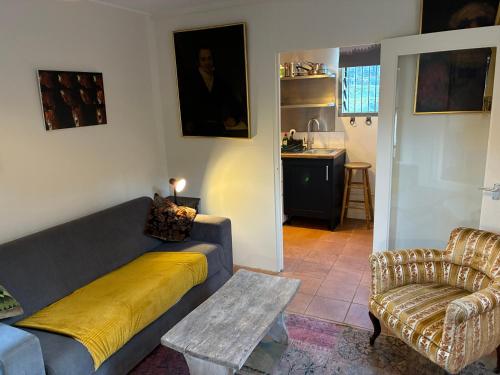 a living room with a couch and a chair at Crockers Farm in Dorking