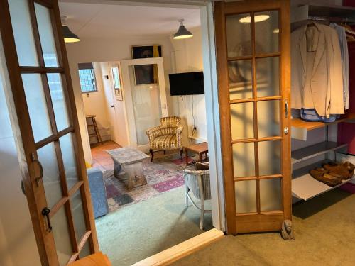 an open door to a room with a living room at Crockers Farm in Dorking