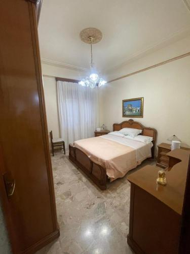 a bedroom with a bed and a chandelier at Brezza Marina in Gallico
