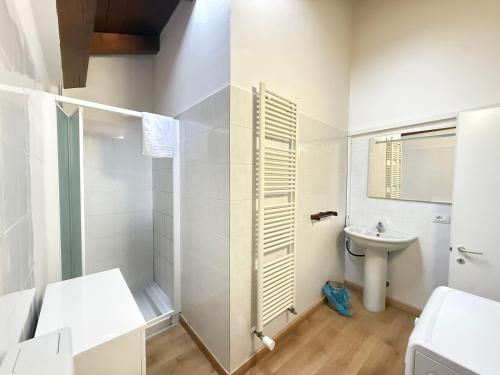 a white bathroom with a sink and a toilet at Nuvola di Parma// del Ducato 1 in Parma