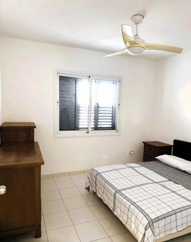 a bedroom with a bed and a ceiling fan at Peyia Spring in Peyia