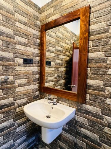 a bathroom with a sink and a mirror at Villa La Mama Beruwala in Beruwala