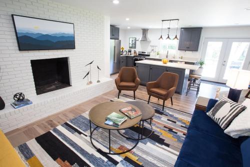 a living room with a couch and a fireplace at Asheville Relaxing Sanctuary Arboretum adjacent in Asheville