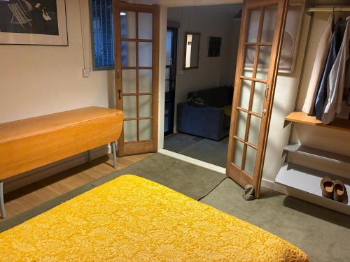 a bedroom with a bed and a room with a closet at Crockers Farm in Dorking