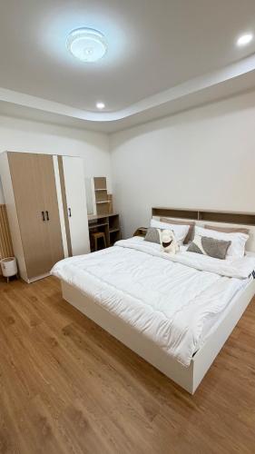 a bedroom with a large white bed in a room at Mnp home in Chiang Rai