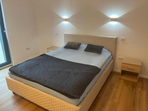 a bed in a bedroom with two pillows on it at Central BB Apartment with Free Parking in Târgu-Mureş