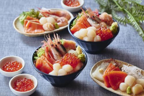 a group of bowls filled with different types of food at Hakodate Hotel Banso in Hakodate