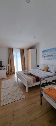 a bedroom with a large bed and a large window at Matea Apartments Milna in Milna