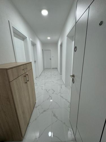 an empty hallway with a door and a tile floor at Apartman Iva in Foča