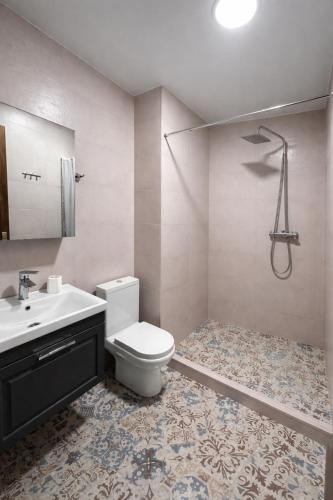 a bathroom with a toilet and a sink and a shower at Ortevani Guest House in Kvareli
