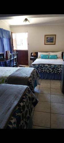 a bedroom with two beds and a window at Eagles guest house Piet Retief in Piet Retief