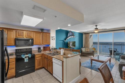 a kitchen and living room with a view of the ocean at Luxury Condo with Huge Private Balcony on Lake Bryan in Orlando