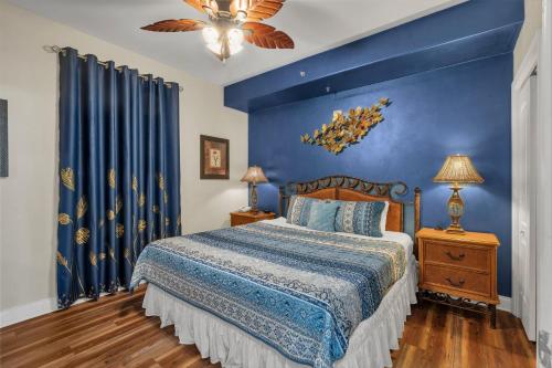a blue bedroom with a bed and a blue wall at Luxury Condo with Huge Private Balcony on Lake Bryan in Orlando