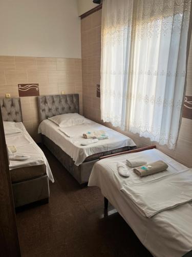 a room with two beds and a window at Villa Jakos Paradise in Batumi