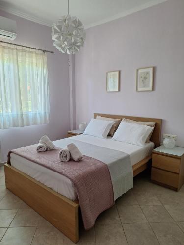 a bedroom with a large bed with towels on it at B&B one in Vonitsa