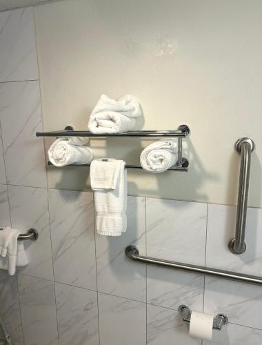 a bathroom with white towels on a wall at Big Springs Inn in Big Springs