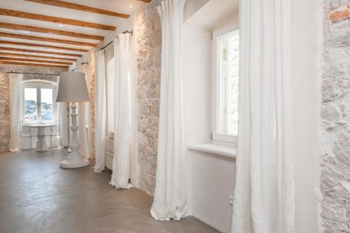 a hallway with white curtains and a window at Riva Lavanda Hvar, Old Town in Hvar