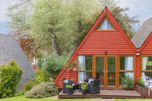 a small house with a red roof at Chalet 53 in Deal