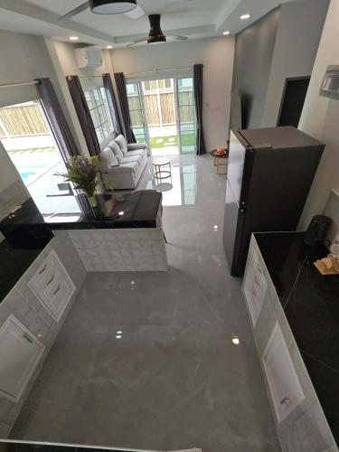 a large living room with a kitchen and a living room at jessi house pool in Ban Nok