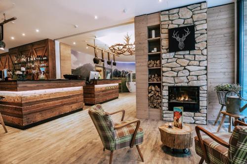 a bar with a stone wall and a fireplace at Cocoon München Hauptbahnhof in Munich