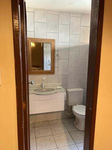 a bathroom with a sink and a toilet at Suítes estrela dalva in Lauro de Freitas